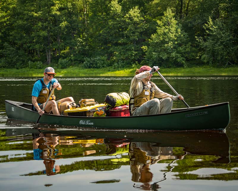 Two men canoeing in the Old Town Discovery 158 Canoe