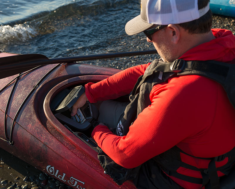 Storing items in dry hatch on Old Town Castine touring kayak