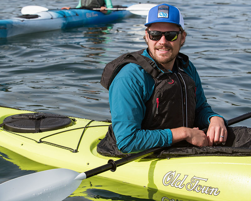 Smiling man in the Old Town Castine touring kayak