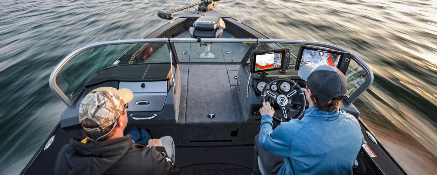 Anglers running to next spot navigating by LakeMaster map on a HELIX on the dash