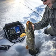 Ice fisherman using a Humminbird ICE HELIX unit and catching a fish